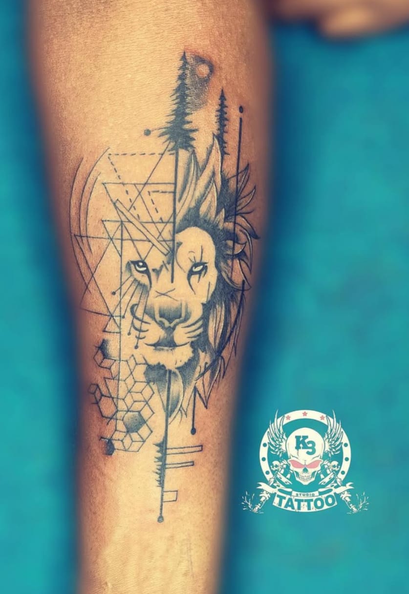 Geometric lion tattoo on forearm blending realism with dot-work and line patterns