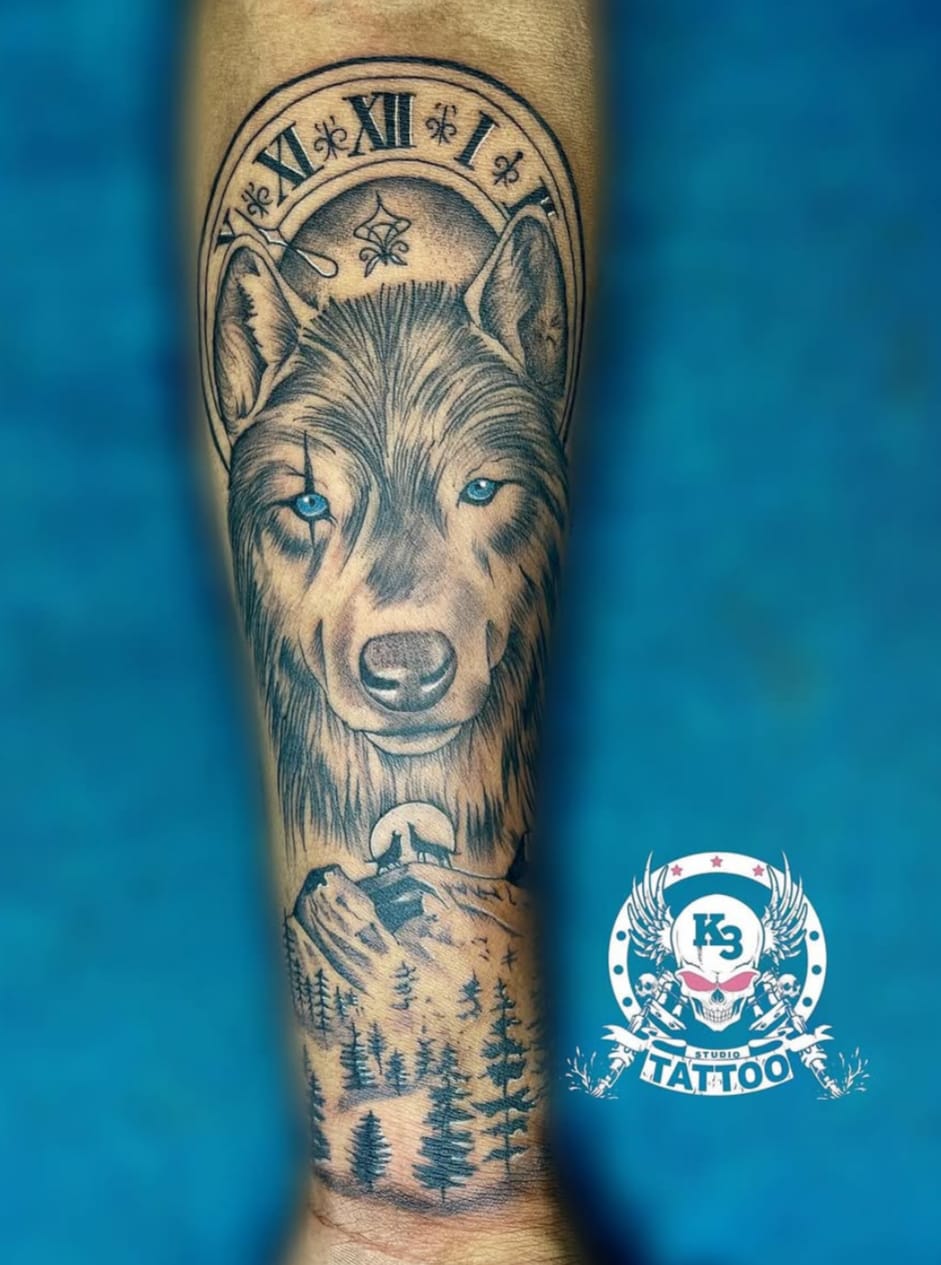 Realistic wolf portrait tattoo on forearm with a forest and clock face design